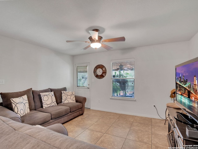 tiled living room with ceiling fan