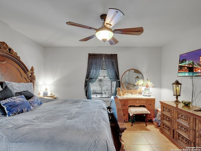 tiled bedroom featuring ceiling fan