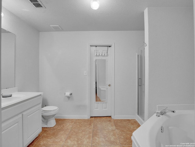 bathroom featuring vanity, a textured ceiling, tile patterned floors, and a tub