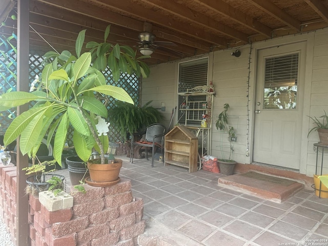 property entrance featuring ceiling fan and a patio area