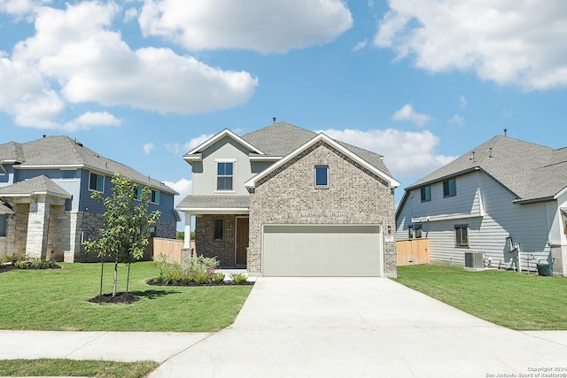 view of front facade with a garage, central air condition unit, and a front lawn