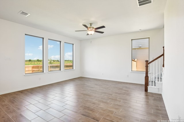 spare room featuring ceiling fan and light hardwood / wood-style floors