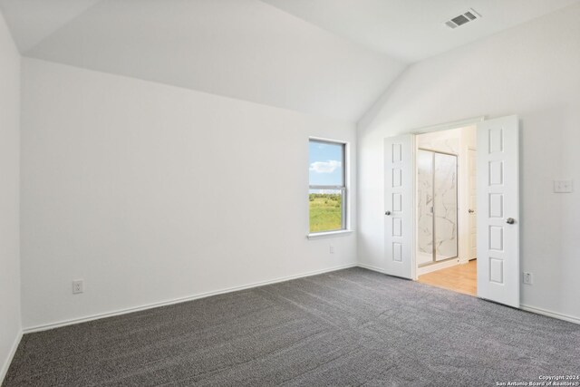 interior space with vaulted ceiling and carpet