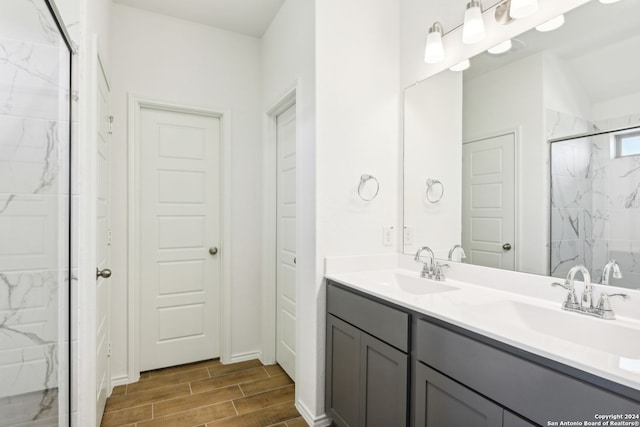 bathroom featuring walk in shower and vanity