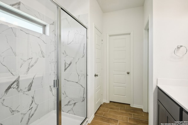 bathroom with vanity and a shower with shower door