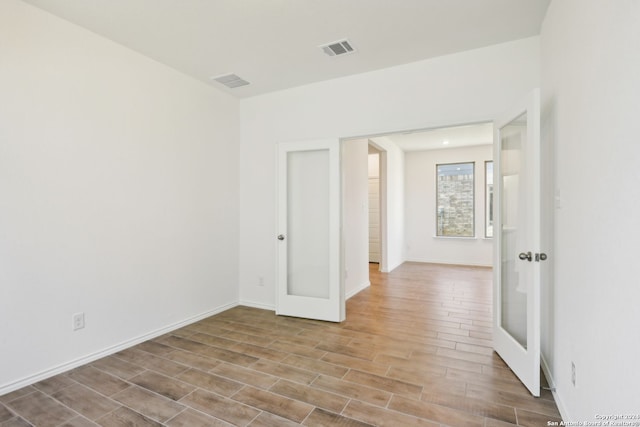 spare room featuring french doors