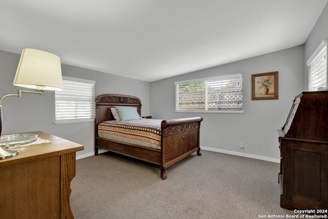 bedroom with lofted ceiling and carpet flooring