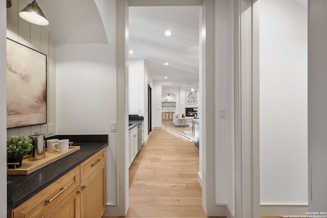 hallway with light wood-type flooring and recessed lighting