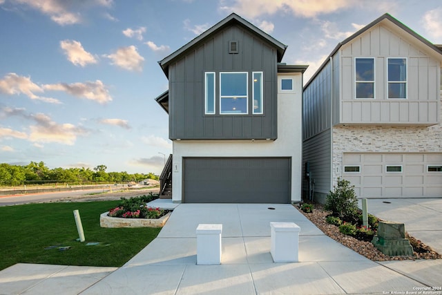 view of front of house featuring a garage and a front lawn