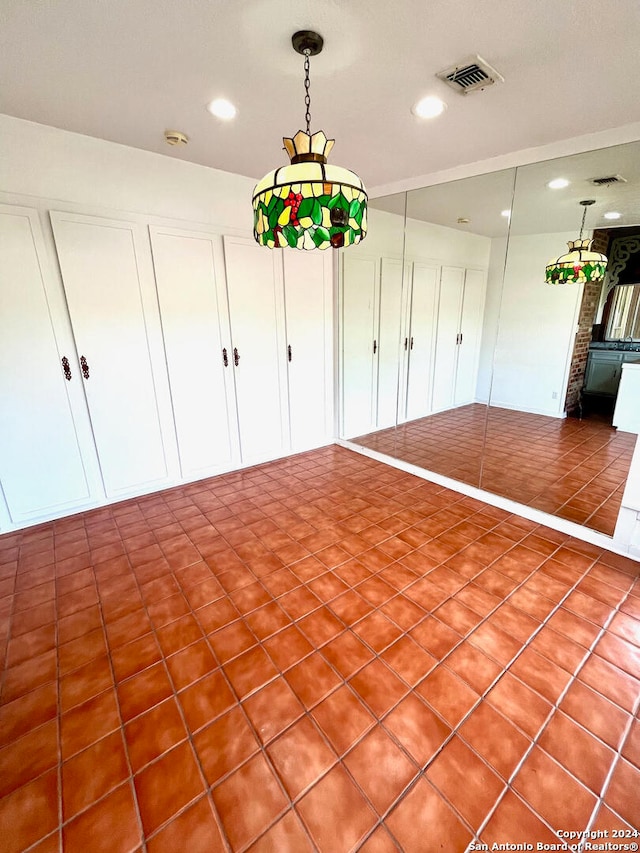 unfurnished dining area featuring tile floors