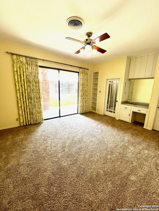 unfurnished bedroom with ceiling fan, access to exterior, and carpet flooring