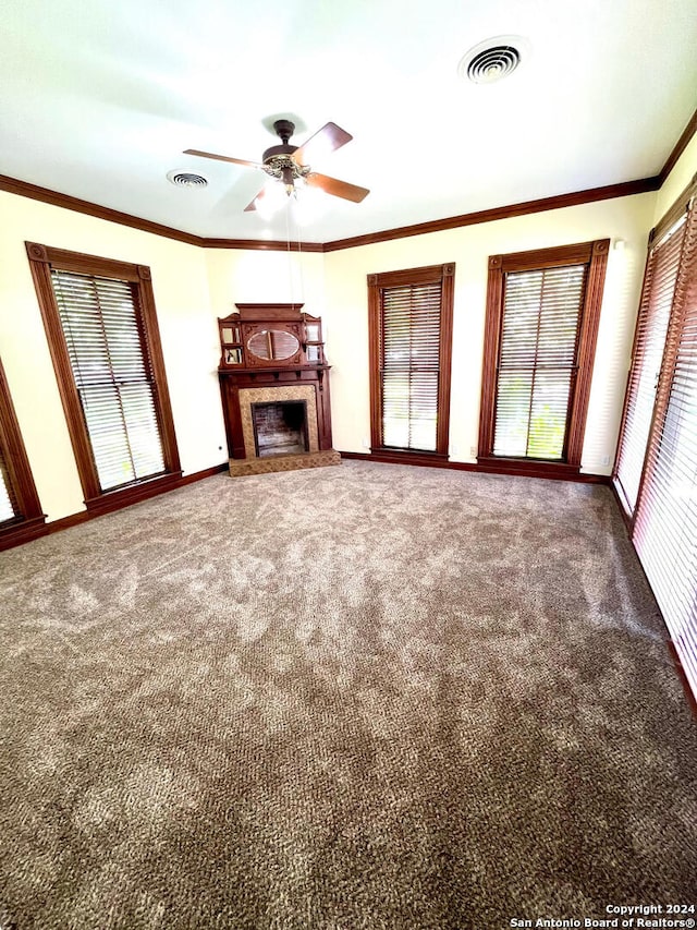 unfurnished living room featuring ceiling fan, carpet floors, and crown molding