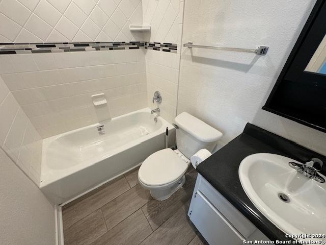 full bathroom with vanity, toilet, and tiled shower / bath