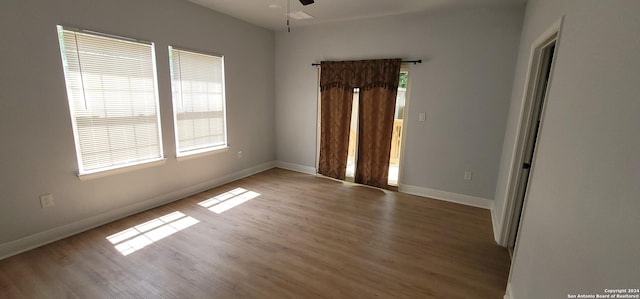 unfurnished room featuring hardwood / wood-style flooring and ceiling fan