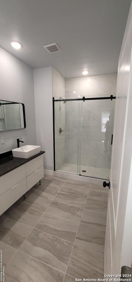 bathroom with vanity and an enclosed shower