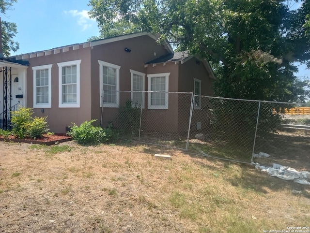 view of side of property with a lawn