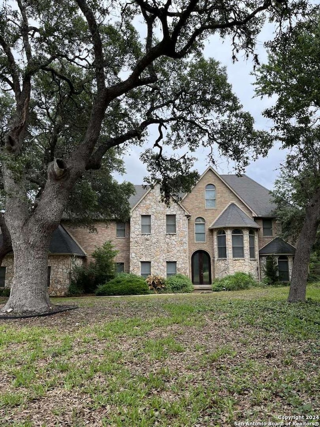 french provincial home featuring a front lawn