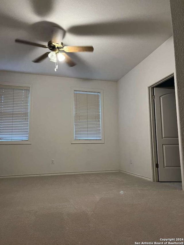 empty room featuring carpet and ceiling fan