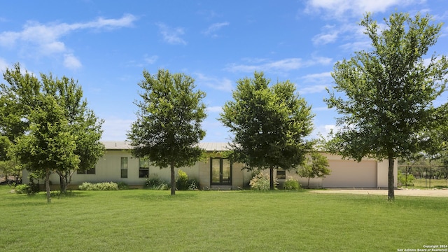 view of front of property featuring a garage and a front lawn