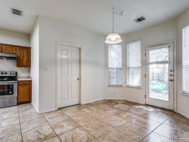 kitchen featuring light tile patterned flooring, ventilation hood, decorative light fixtures, and stainless steel range oven