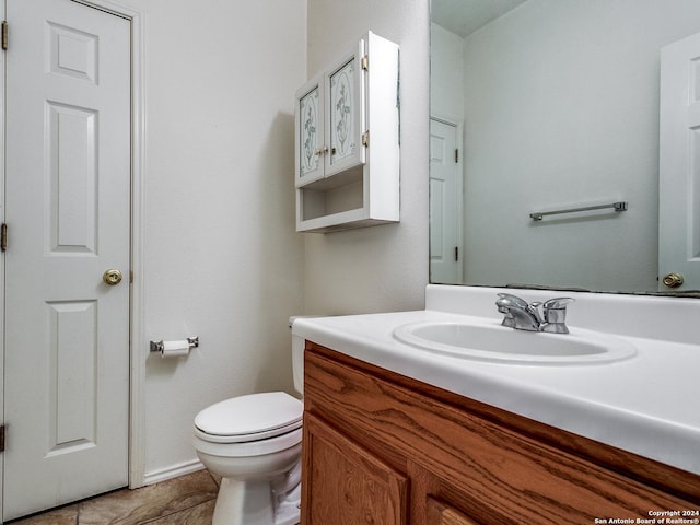 bathroom featuring tile patterned floors, vanity, and toilet