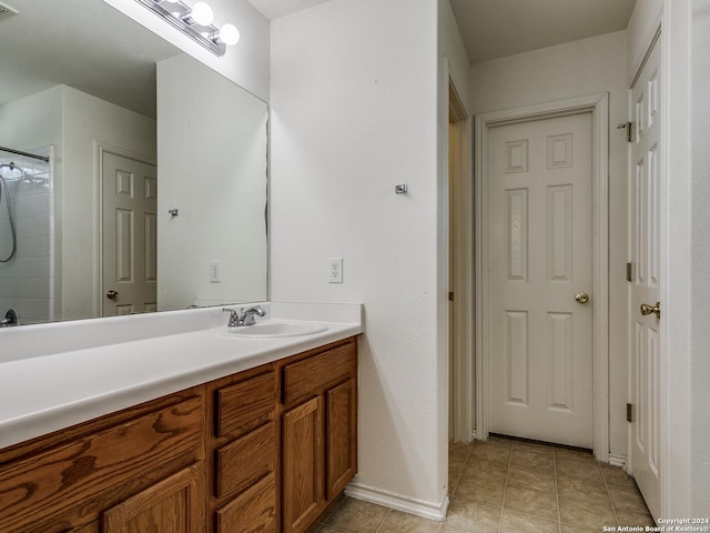 bathroom featuring tile patterned flooring and vanity