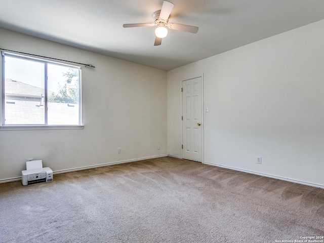 empty room featuring carpet flooring and ceiling fan