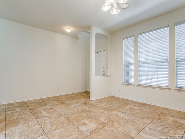 tiled spare room with a wealth of natural light