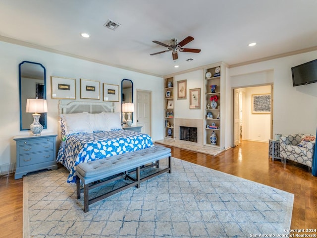 bedroom with ceiling fan, light hardwood / wood-style floors, and ornamental molding