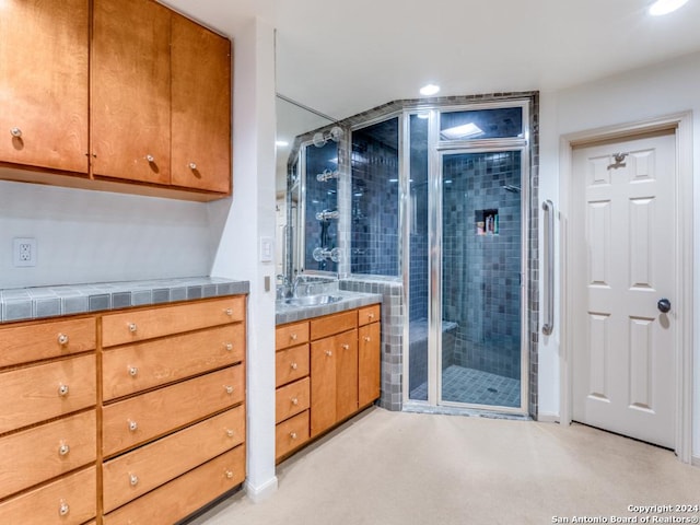 bathroom featuring vanity and a shower with door