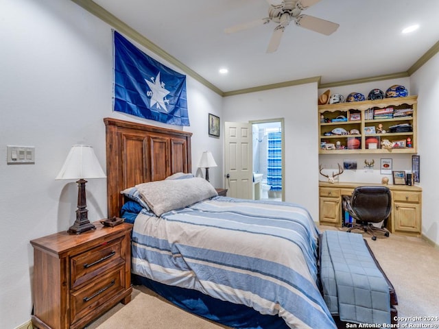 bedroom with carpet flooring, ensuite bath, ceiling fan, and ornamental molding