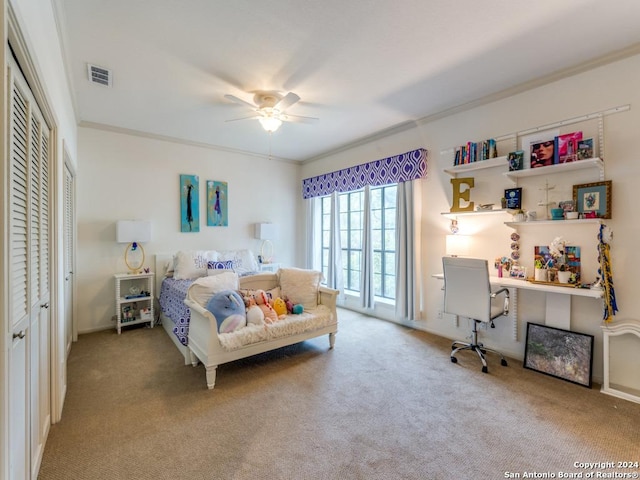 carpeted bedroom with ceiling fan and ornamental molding