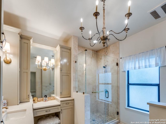 bathroom with vanity, an inviting chandelier, and walk in shower