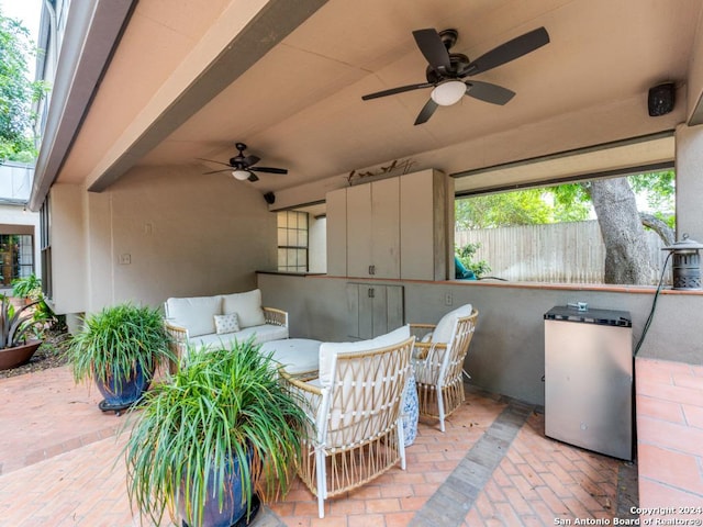 view of patio with ceiling fan, an outdoor hangout area, and exterior bar