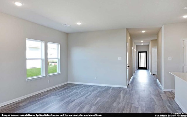 unfurnished room with wood-type flooring