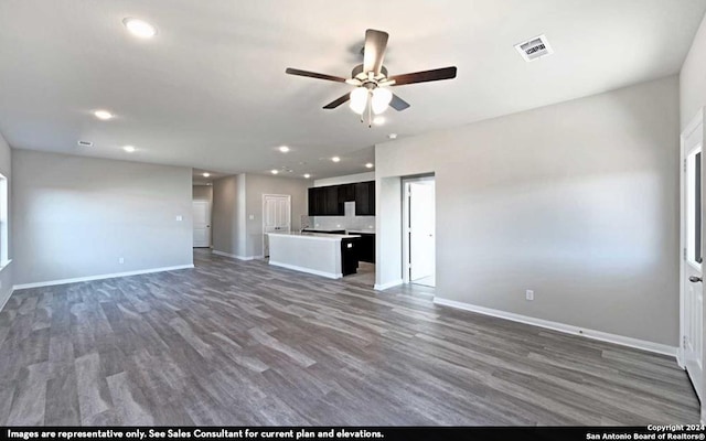 unfurnished living room featuring ceiling fan and hardwood / wood-style floors