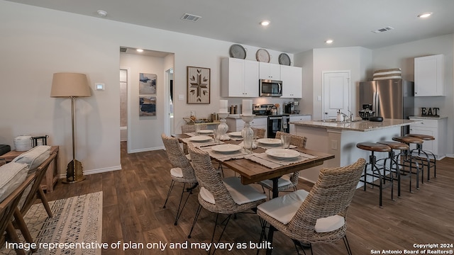 dining room with sink and dark hardwood / wood-style floors