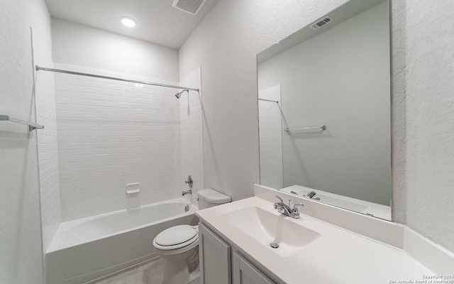 full bathroom with toilet, vanity, and tiled shower / bath