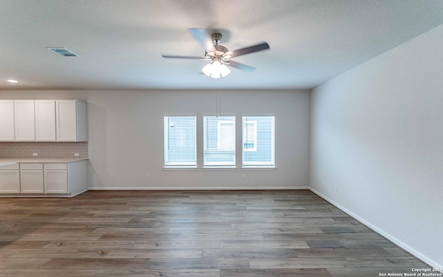 interior space with ceiling fan and light wood-type flooring