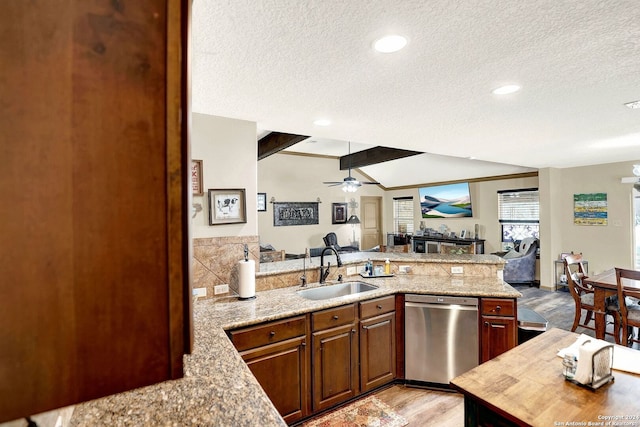 kitchen with light hardwood / wood-style floors, a textured ceiling, ceiling fan, sink, and dishwasher