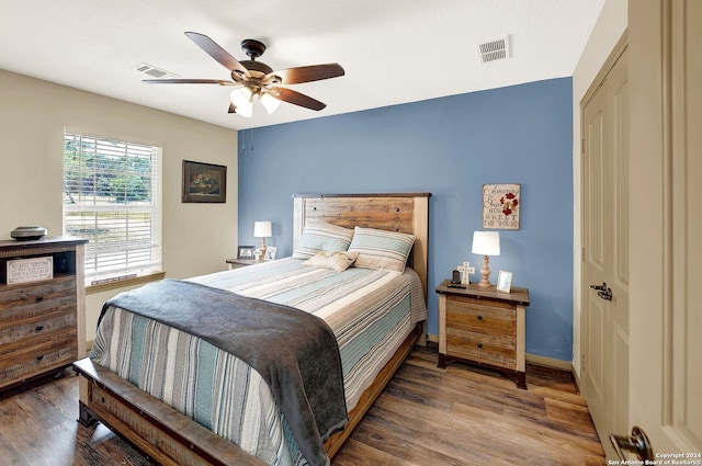 bedroom with ceiling fan, a closet, and hardwood / wood-style floors