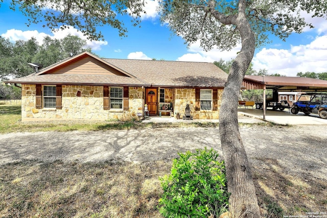 ranch-style house with a porch and a carport