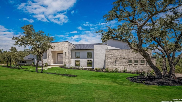 rear view of property with a yard