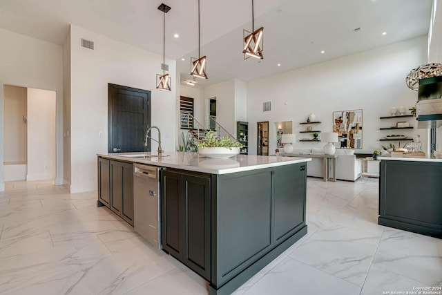 kitchen with a high ceiling, a sink, visible vents, marble finish floor, and stainless steel dishwasher