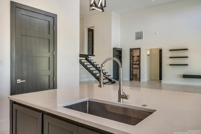 kitchen with a towering ceiling and sink