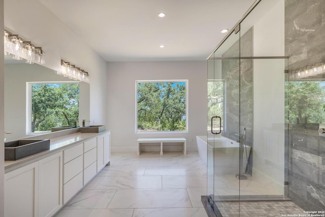 bathroom featuring tile floors, an enclosed shower, a wealth of natural light, and vanity