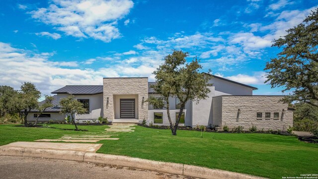 contemporary home featuring a front lawn