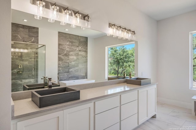 bathroom with tile floors, walk in shower, and double vanity