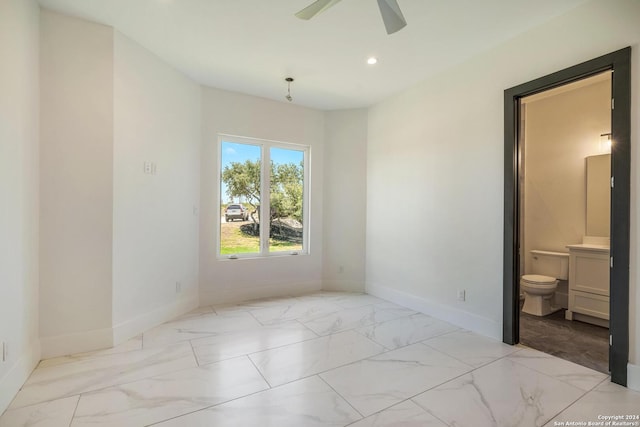 unfurnished bedroom with light tile flooring, ceiling fan, and ensuite bath