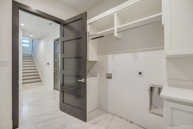 clothes washing area featuring hookup for an electric dryer, light tile floors, and washer hookup